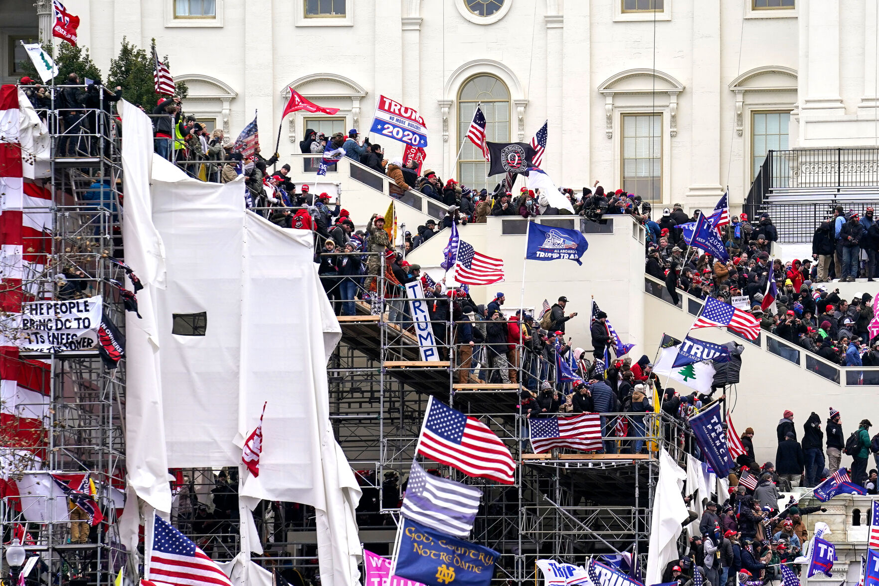 Pro-Trump rioters gather on risers outside the Capitol